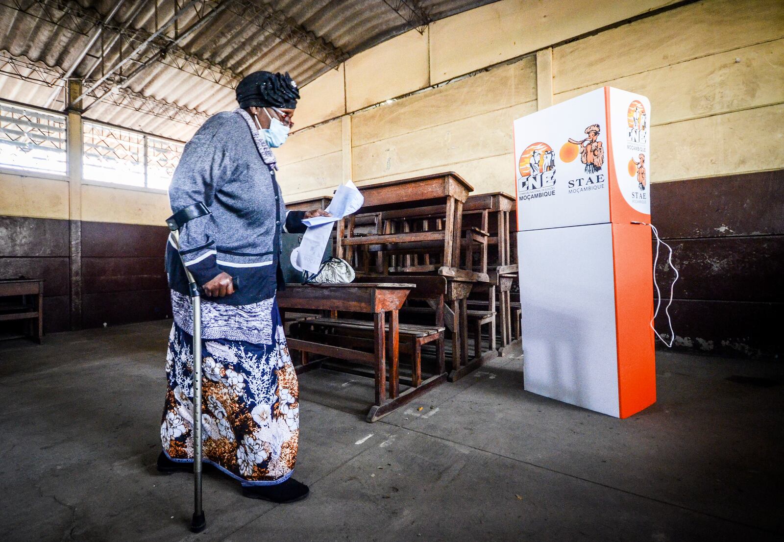 A woman carries a ballot at a polling station to cast her vote in general elections in Maputo, Mozambique, Wednesday, Oct. 9, 2024. (AP Photo/Carlos Equeio)