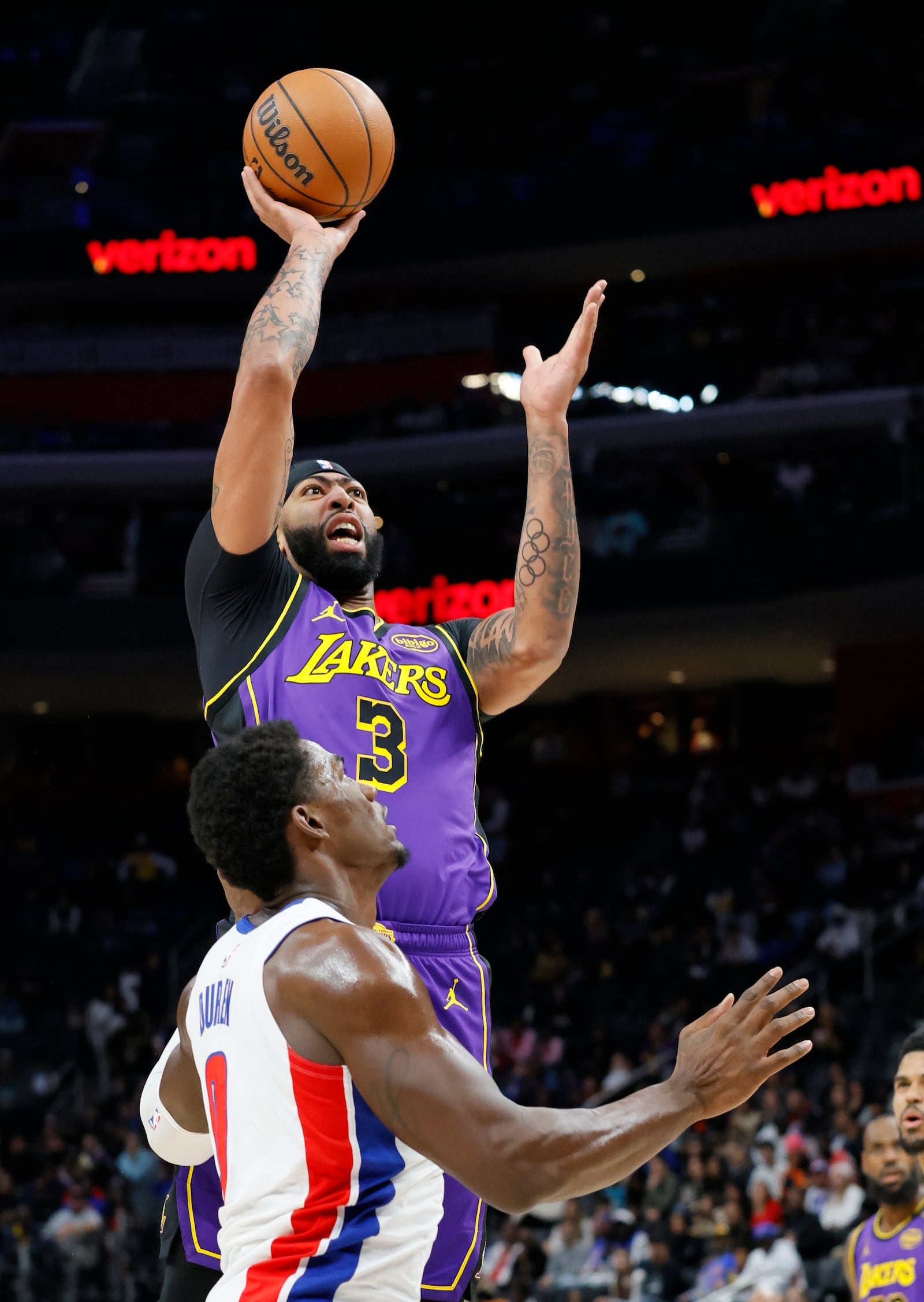 Los Angeles Lakers forward Anthony Davis (3) shoots over Detroit Pistons center Jalen Duren (0) during the first half of an NBA basketball game Monday, Nov. 4, 2024, in Detroit. (AP Photo/Duane Burleson)