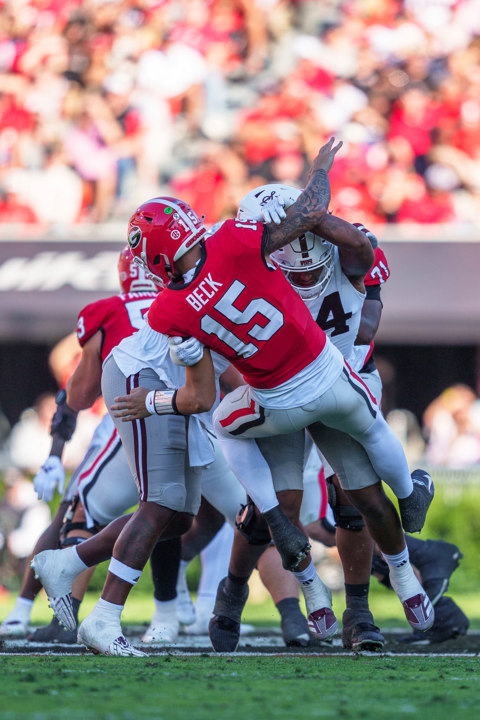 Georgia quarterback Carson Beck (15) is hit in the back field during an NCAA college football game against Mississippi State, Saturday, Oct. 12, 2024, in Athens, Ga. (AP Photo/Jason Allen)