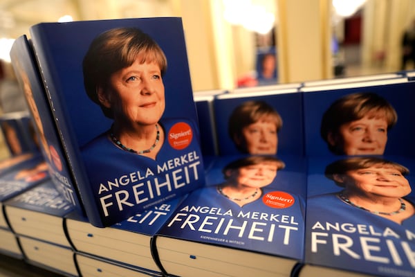 Editions of former German Chancellor Angela Merkel's memories are displayed during the official presentation of the book in Berlin, Germany, Tuesday, Nov. 26, 2024. (AP Photo/Markus Schreiber)