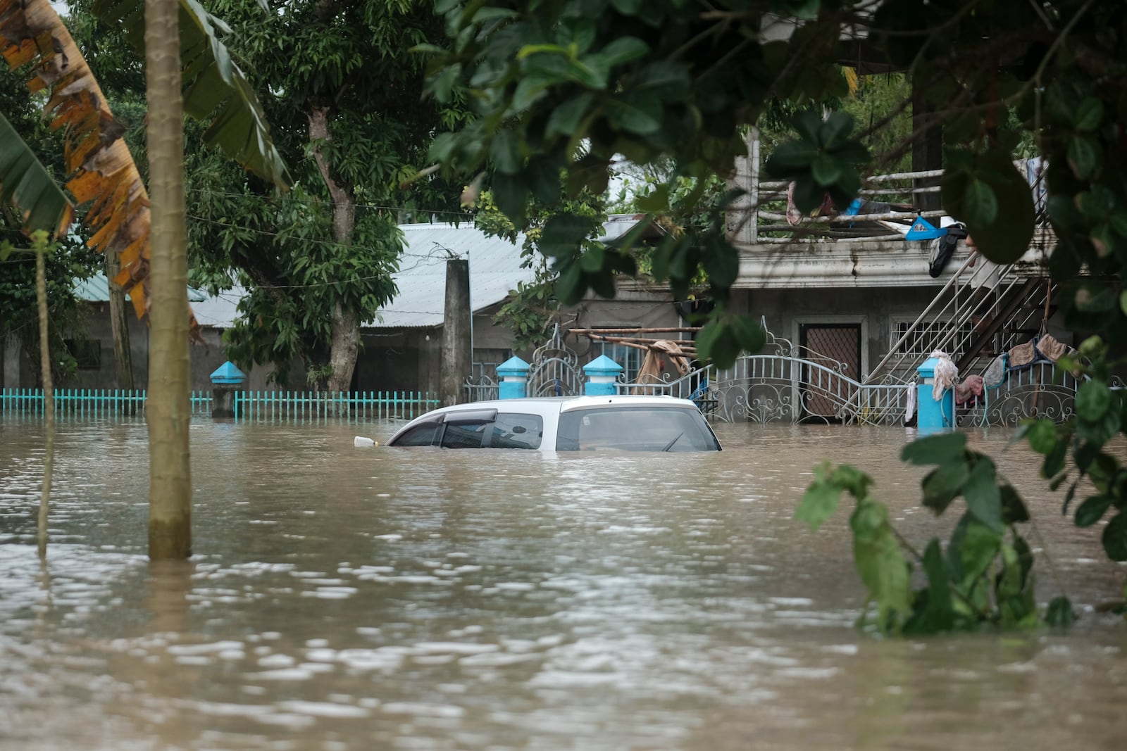 A submerged vehicle is seen in floods caused by Tropical Storm Trami, locally named Kristine, as it continues to inundate Libon town, Albay province, Philippines on Thursday Oct. 24, 2024. (AP Photo/John Michael Magdasoc)