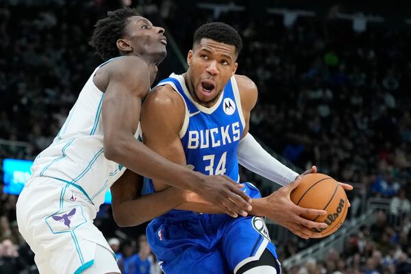 Charlotte Hornets' Moussa Diabate fouls Milwaukee Bucks' Giannis Antetokounmpo during the second half of an NBA basketball game Saturday, Nov. 23, 2024, in Milwaukee. The Bucks won 125-119. (AP Photo/Morry Gash)