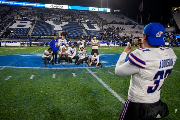 Kansas punter Grayden Addison (37) snaps a shot of his team mates after Kansas defeated BYU, in an NCAA college football game Saturday, Nov. 16, 2024, in Provo. (AP Photo/Rick Egan)