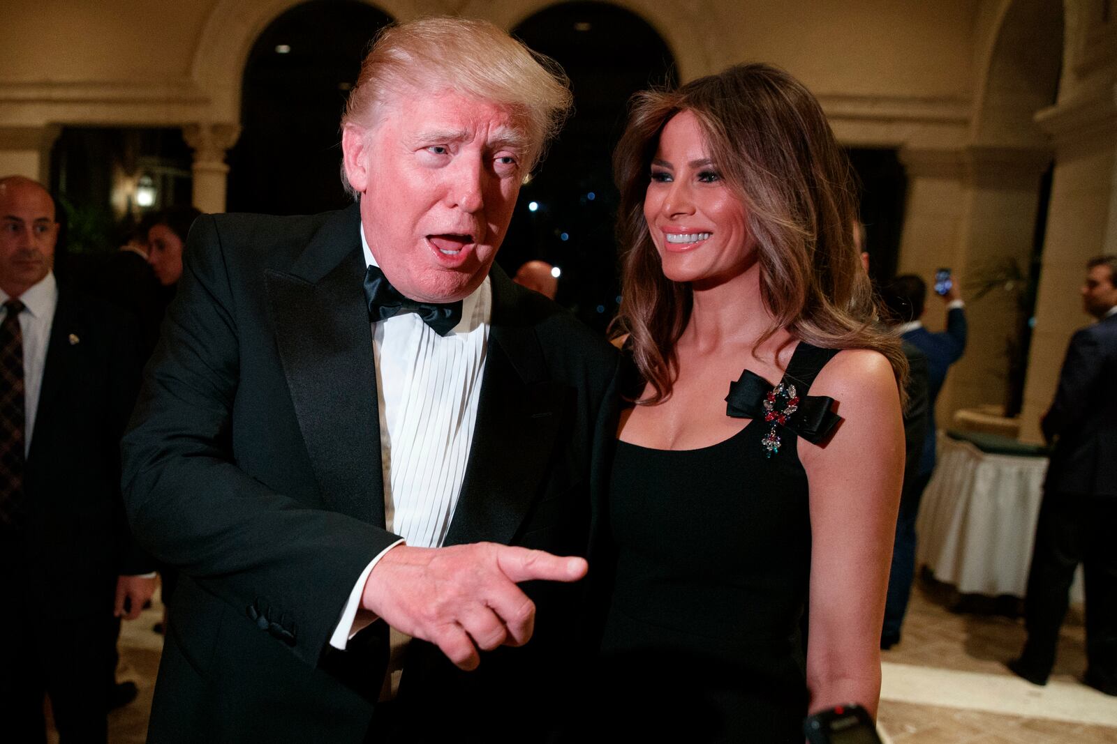 FILE - Melania Trump, right, looks on as her husband President-elect Donald Trump talks to reporters during a New Year's Eve party at Mar-a-Lago, Dec. 31, 2016, in Palm Beach, Fla. (AP Photo/Evan Vucci, File)