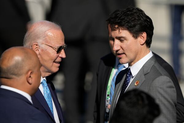 U.S. President Joe Biden, left, and Canada's Prime Minister Justin Trudeau, arrive late for a group photo during the G20 Summit in Rio de Janeiro, Monday, Nov. 18, 2024. (AP Photo/Eraldo Peres)