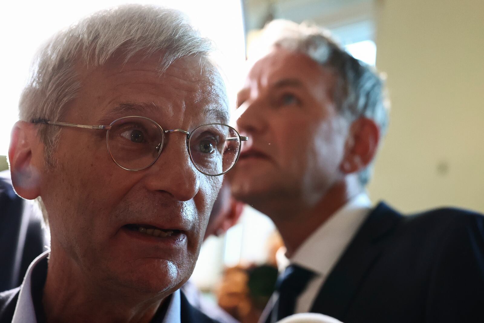 Right-wing Alternative for Germany (AfD) Brandenburg top candidate Hans-Christoph Berndt and Thuringia AfD party leader Bjoern Hoecke react, after first exit polls of the Brandenburg state election in Potsdam, Germany, Sunday, Sept. 22, 2024. (Liesa Johannssen/Pool Photo via AP)