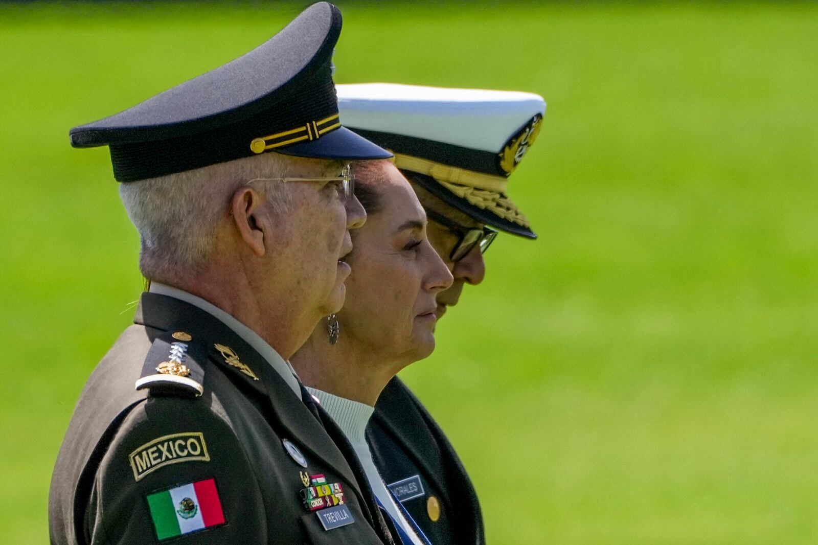 Mexican President Claudia Sheinbaum, center, reviews the troops with Defense Minister Gen. Ricardo Trevilla Trejo, left, and Navy Secretary Alt. Raymundo Pedro Morales at Campo Marte in Mexico City, Thursday, Oct. 3, 2024. (AP Photo/Fernando Llano)