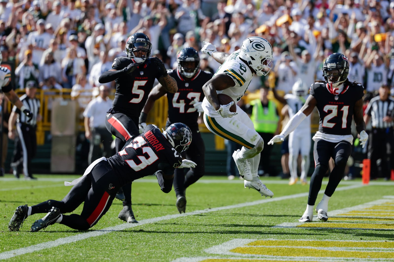 Green Bay Packers running back Josh Jacobs (8) scores a touchdown during the second half of an NFL football game against the Houston Texans, Sunday, Oct. 20, 2024, in Green Bay, Wis. (AP Photo/Matt Ludtke)