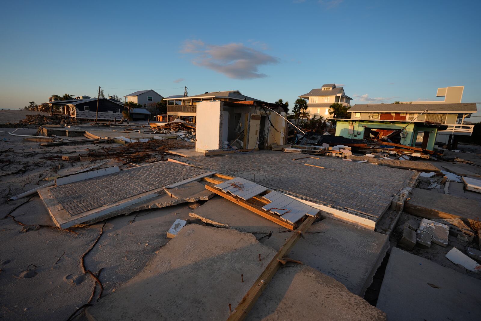 Two beachfront foundations are seen stripped of the buildings that stood on them, after Hurricane Milton, on Manasota Key, Fla., Saturday, Oct. 12, 2024. (AP Photo/Rebecca Blackwell)