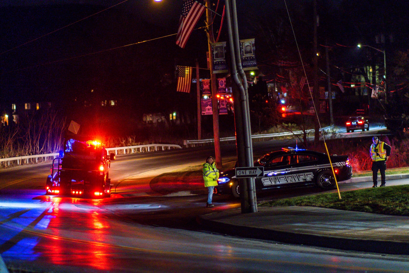 Police officers stand guard on a local road as wildfires burn along the New York and New Jersey border in Greenwood Lake, New York, Wednesday, Nov. 13, 2024. (AP Photo/Eduardo Munoz Alvarez)