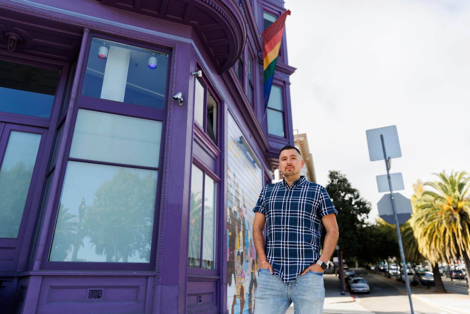 Luis A. Torres stands for a portrait in front of the " Joy is the Fuel" mural by Cuban-American artist Alma Landeta at the SF LGBT Center on Friday, Sept. 20, 2024, in San Francisco. (AP Photo/Juliana Yamada)