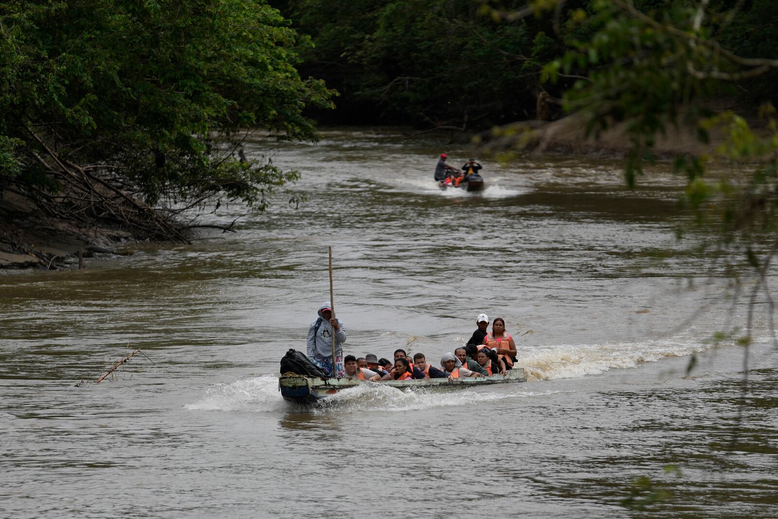 A boat takes migrants to Lajas Blanca, Panama, Thursday, Sept. 26, 2024, after their trek across the Darien Gap from Colombia in hopes of reaching the U.S. (AP Photo/Matias Delacroix)