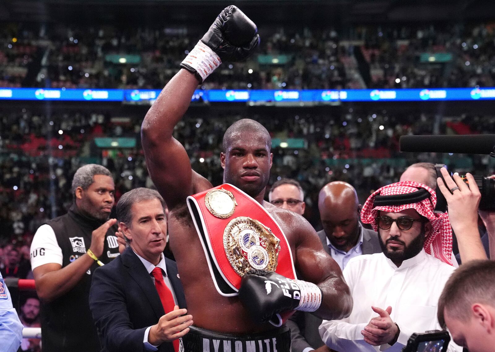 Daniel Dubois, center, celebrates victory against Anthony Joshua, not pictured, in the IBF World Heavyweight bout at Wembley Stadium, in London, Saturday, Sept. 21, 2024. (Bradley Collyer/PA via AP)