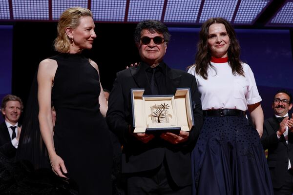 Director Jafar Panahi, centre, accepts the Palme d'Or for the film 'It Was Just an Accident', as he poses with Cate Blanchett, left, and jury president Juliette Binoche during the awards ceremony of the 78th international film festival, Cannes, southern France, Saturday, May 24, 2025. (Photo by Joel C Ryan/Invision/AP)