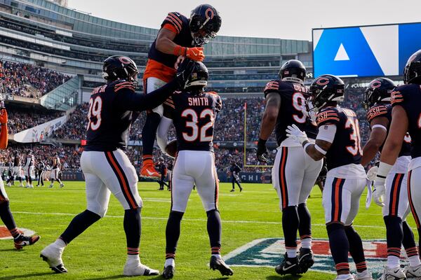 Chicago Bears' Kyler Gordon congratulates MarShawn Lloyd (32) after Lloyd's interception during the first half of an NFL football game against the Green Bay Packers Sunday, Nov. 17, 2024, in Chicago. (AP Photo/Nam Y. Huh)