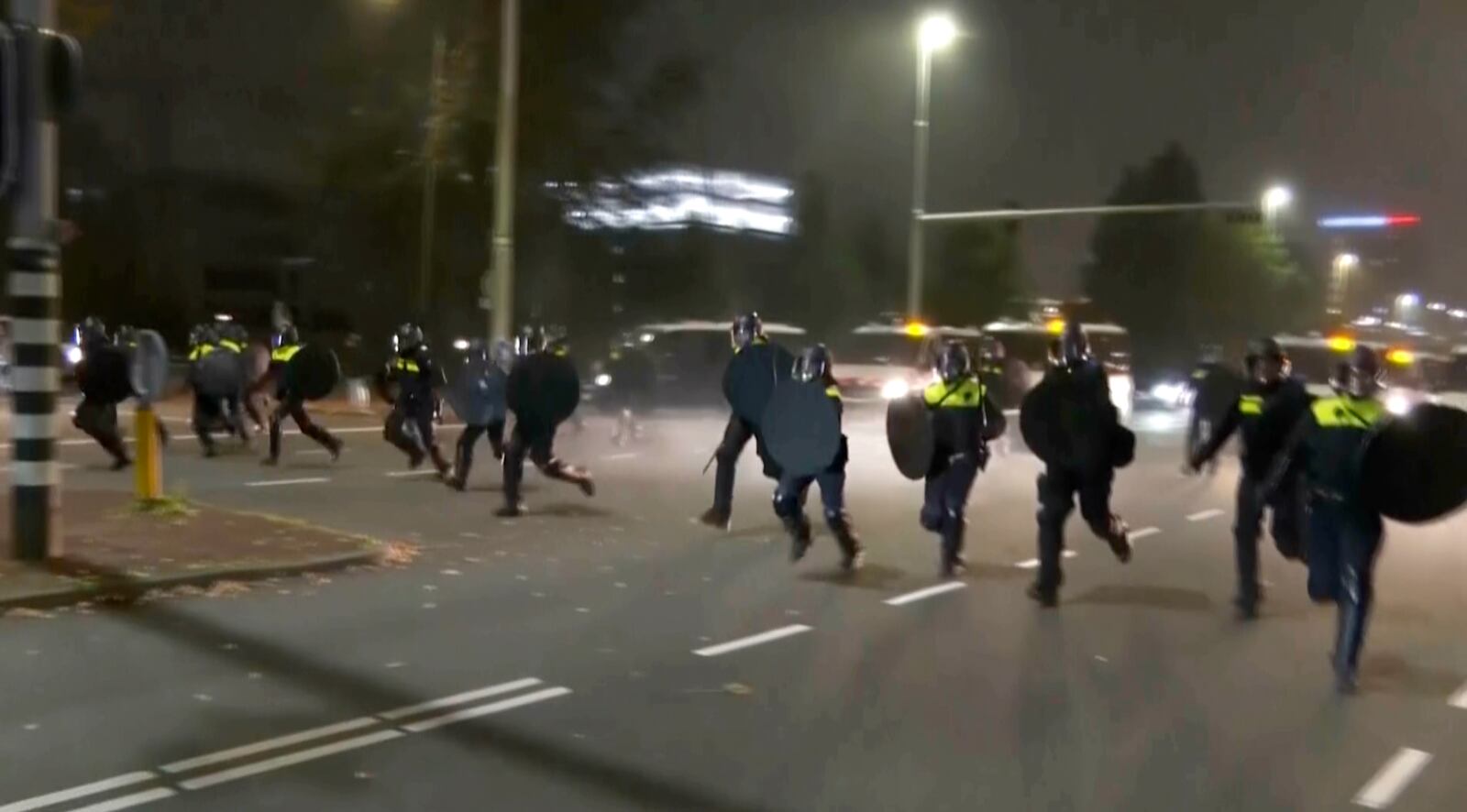 In this image taken from video, police in riot gear run towards protesters, after pro-Palestinian supporters marched near the soccer stadium, in Amsterdam, Netherlands, Thursday, Nov. 7, 2024. (RTL Nieuws via AP)