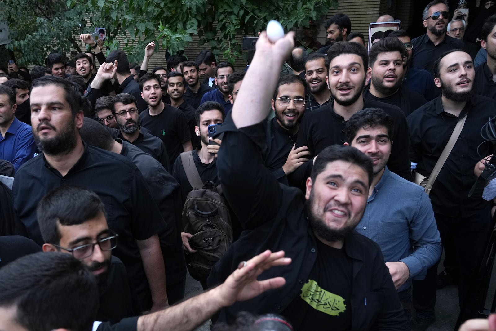 FILE -A demonstrator throws an egg at the Swedish Embassy during a protest for the desecration of the Quran in Sweden, July 21, 2023, in Tehran, Iran. (AP Photo/Vahid Salemi, File)