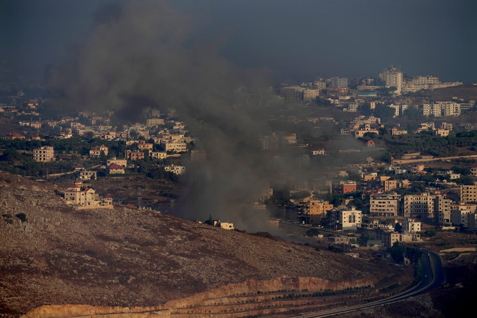 Smoke rises from an Israeli airstrike on Kfar Rouman village, as seen from Marjayoun town, south Lebanon, Monday, Sept. 23, 2024. (AP Photo/Hussein Malla)