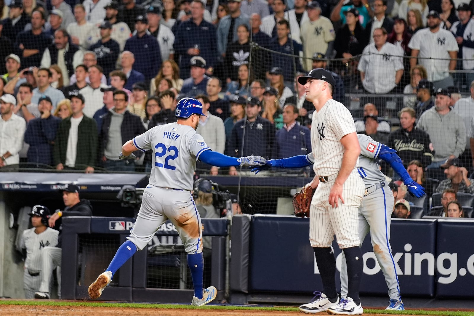 Kansas City Royals' Tommy Pham (22) scores as New York Yankees pitcher Carlos Rodón looks on during the fourth inning of Game 2 of the American League baseball playoff series, Monday, Oct. 7, 2024, in New York. (AP Photo/Seth Wenig)