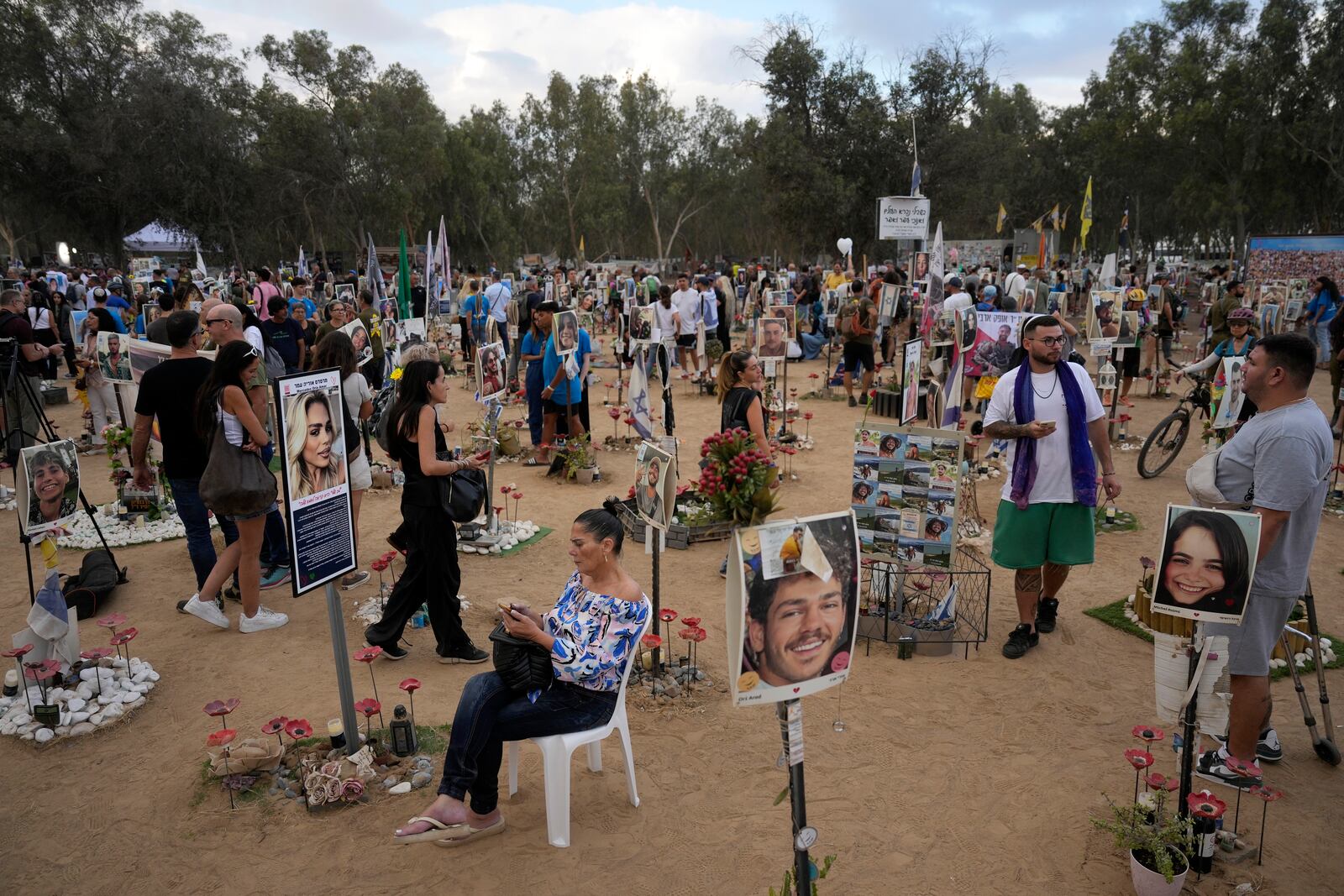 People visit the site of the Nova music festival, where hundreds of revelers were killed and abducted by Hamas and taken into Gaza, on the one-year anniversary of the attack, near Kibbutz Reim, southern Israel, Monday, Oct. 7, 2024. (AP Photo/Ariel Shalit)