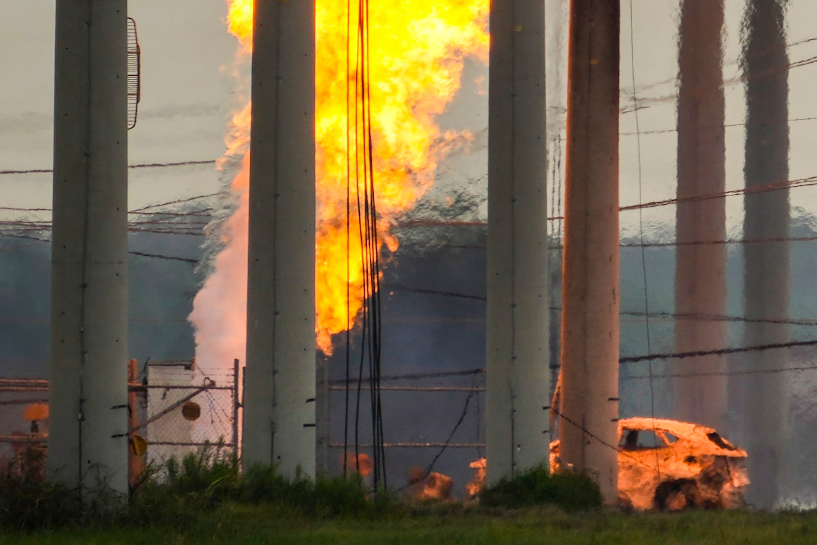 A massive pipeline fire burns after a vehicle drove through a fence along a parking lot and struck an above-ground valve near Spencer Highway and Summerton on Monday, Sept. 16, 2024, in La Porte, Texas. (Brett Coomer/Houston Chronicle via AP)