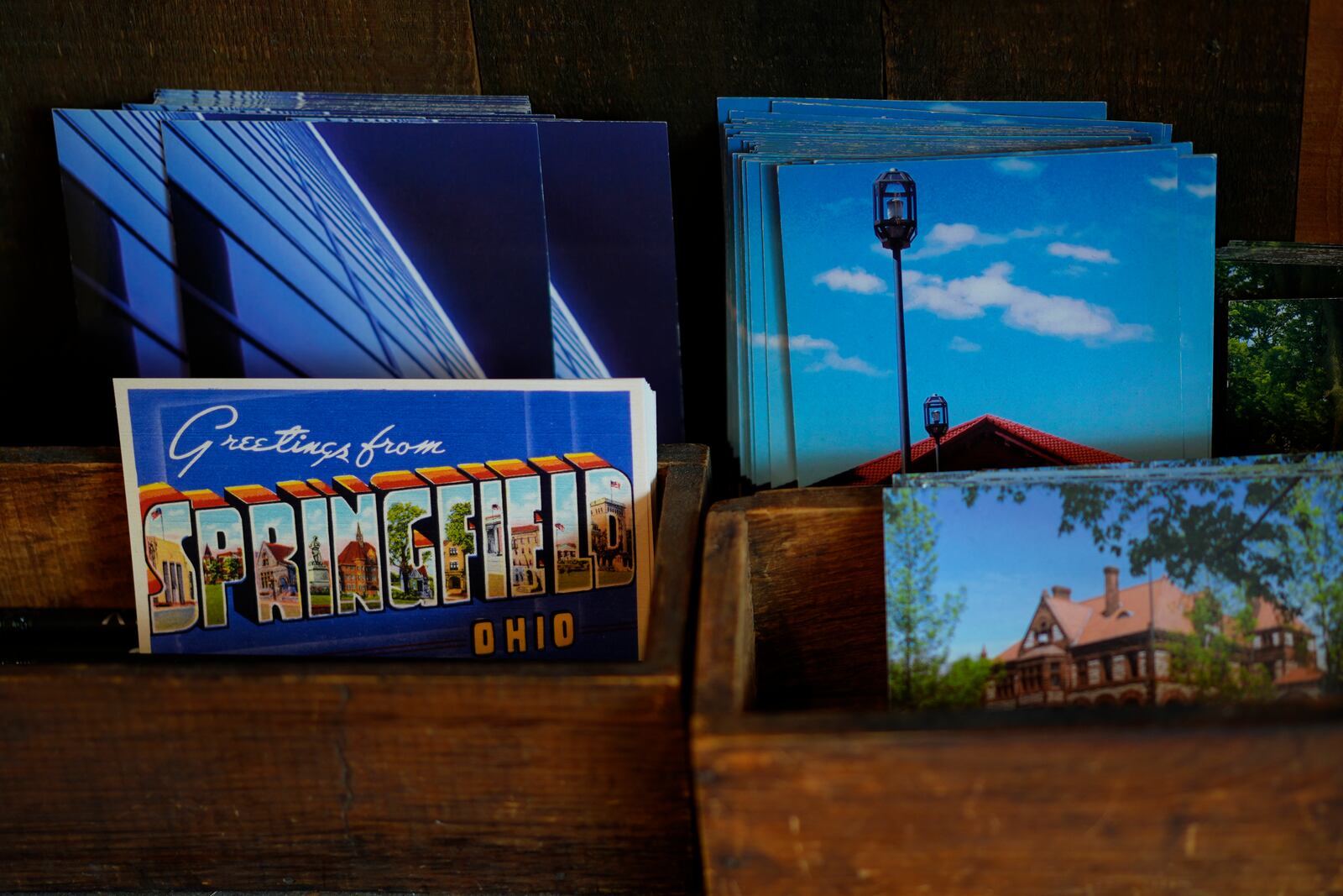 Postcards of Springfield, Ohio, are displayed in the Champion City Guide & Supply, Tuesday, Sept. 17, 2024, in Springfield, Ohio. (AP Photo/Carolyn Kaster)