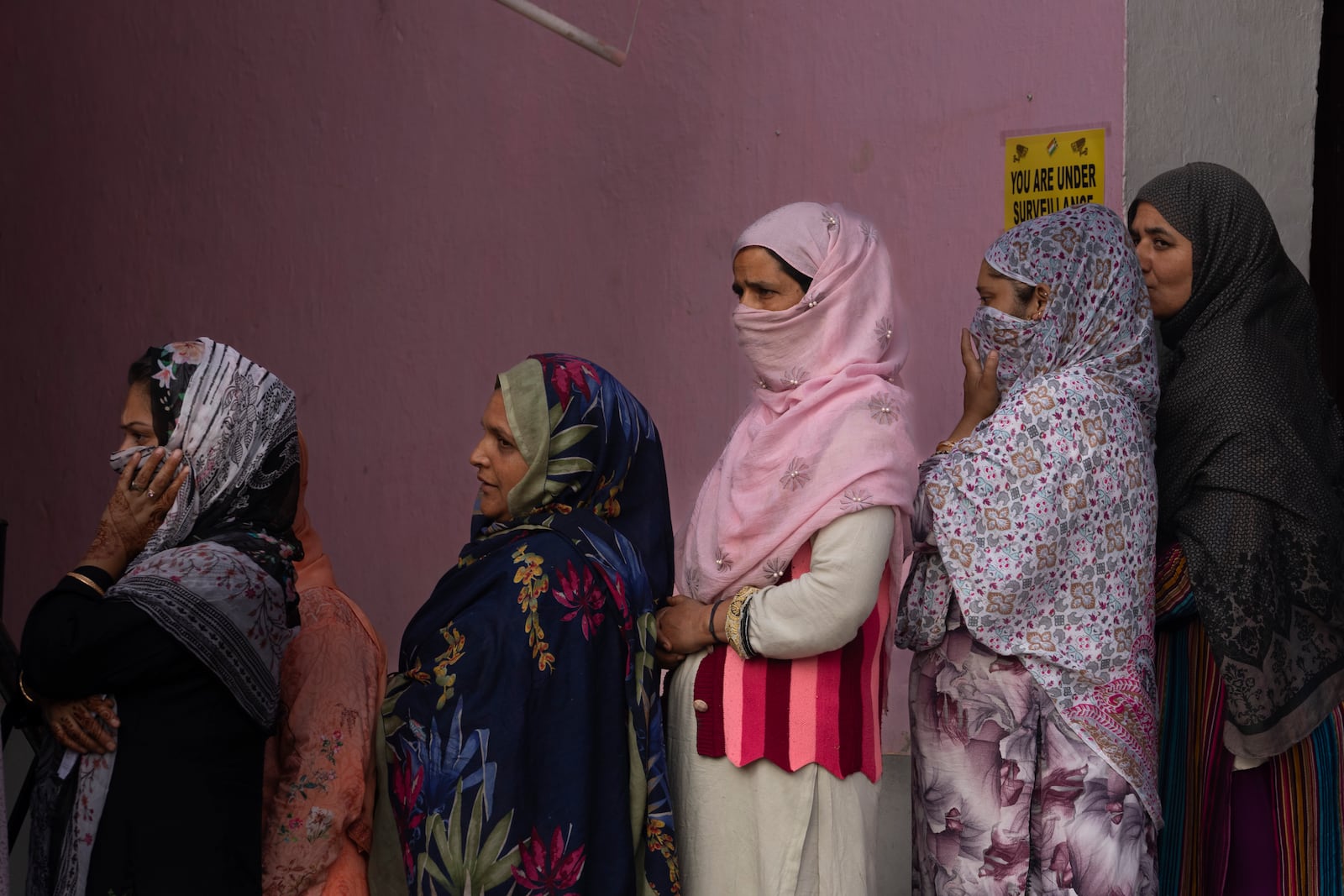 Kashmiri women queue up at a polling booth to cast their vote during the second phase of the assembly election in the outskirts of Srinagar, Indian controlled Kashmir, Wednesday, Sept. 25, 2024. (AP Photo/Dar Yasin)