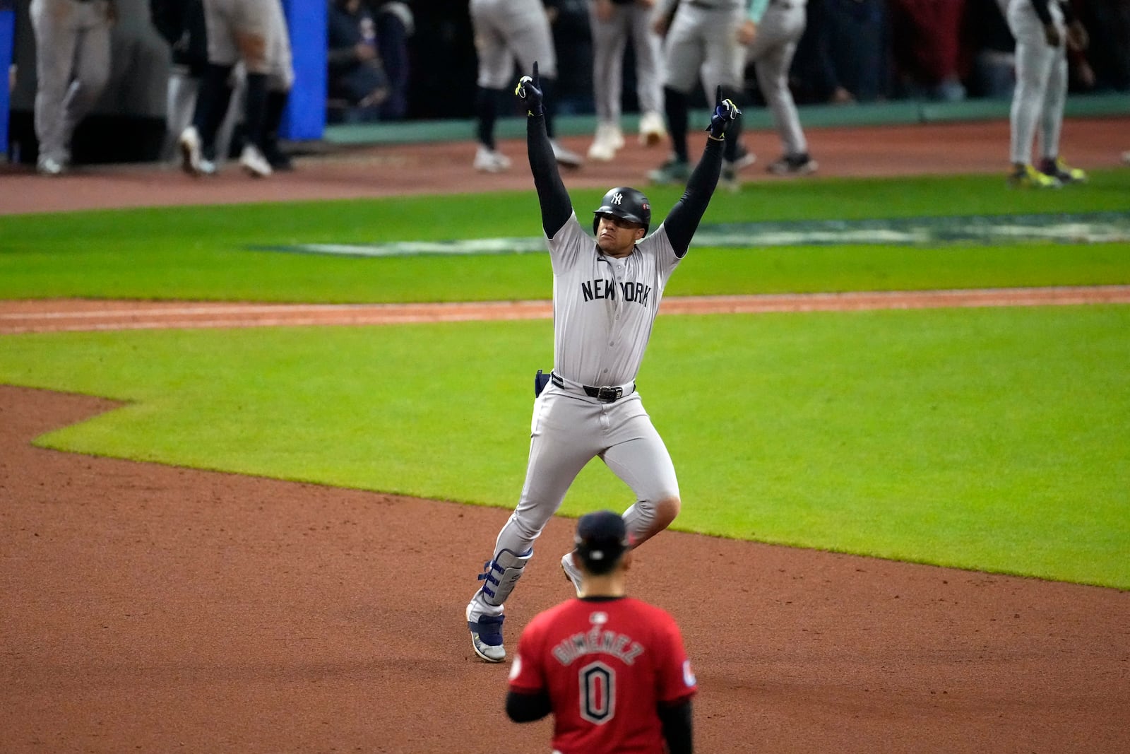 New York Yankees' Juan Soto celebrates after hitting a three-run home run against the Cleveland Guardians during the 10th inning in Game 5 of the baseball AL Championship Series Saturday, Oct. 19, 2024, in Cleveland. (AP Photo/Jeff Roberson)