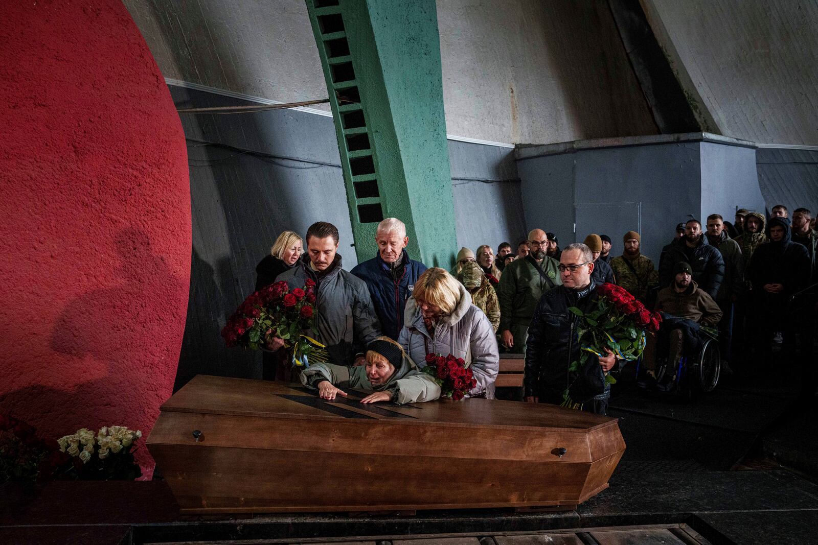 The mother cries over the coffin of her daughter Valentyna Nagorna aka "Valkiria", Ukrainian military medic of 3rd assault brigade who was killed together with his boyfriend Danylo Liashkevych aka "Berserk, during the funeral ceremony at crematorium in Kyiv, Ukraine, Friday, Nov. 8, 2024. (AP Photo/Evgeniy Maloletka)