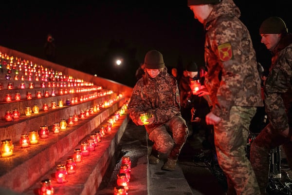 Ukrainian servicemen hold candles during a memorial ceremony marking 1000 days of the Russia Ukraine war in Kyiv, Ukraine, Tuesday Nov. 19, 2024. (AP Photo/Evgeniy Maloletka)