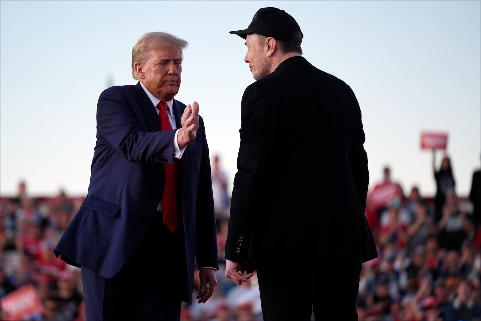 Republican presidential nominee former President Donald Trump shakes hands with Elon Musk at a campaign rally at the Butler Farm Show, Saturday, Oct. 5, 2024, in Butler, Pa. (AP Photo/Evan Vucci)