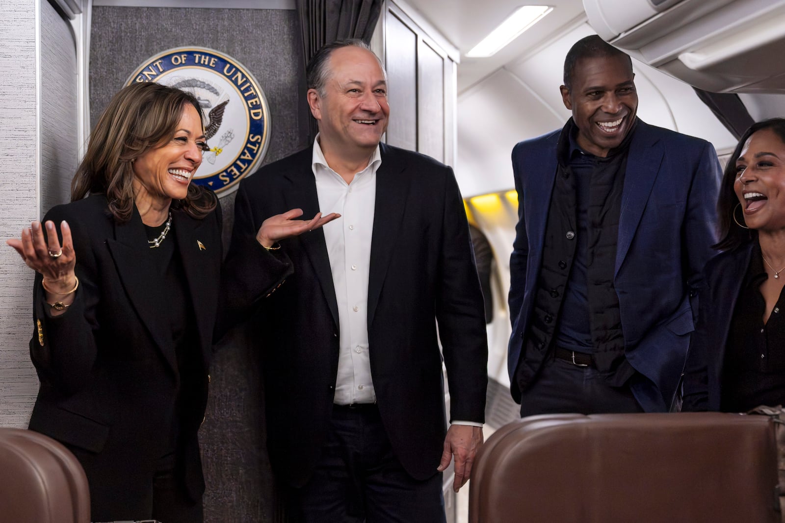 Democratic presidential nominee Vice President Kamala Harris, left, shares a laugh with second gentleman Doug Emhoff, after reuniting in Pittsburgh, Monday, Nov. 4, 2024, aboard Air Force Two along with Harris' brother-in-law Tony West and sister Maya Harris, just before taking off from Pittsburgh for her final campaign rally in Philadelphia. (AP Photo/Jacquelyn Martin, Pool)