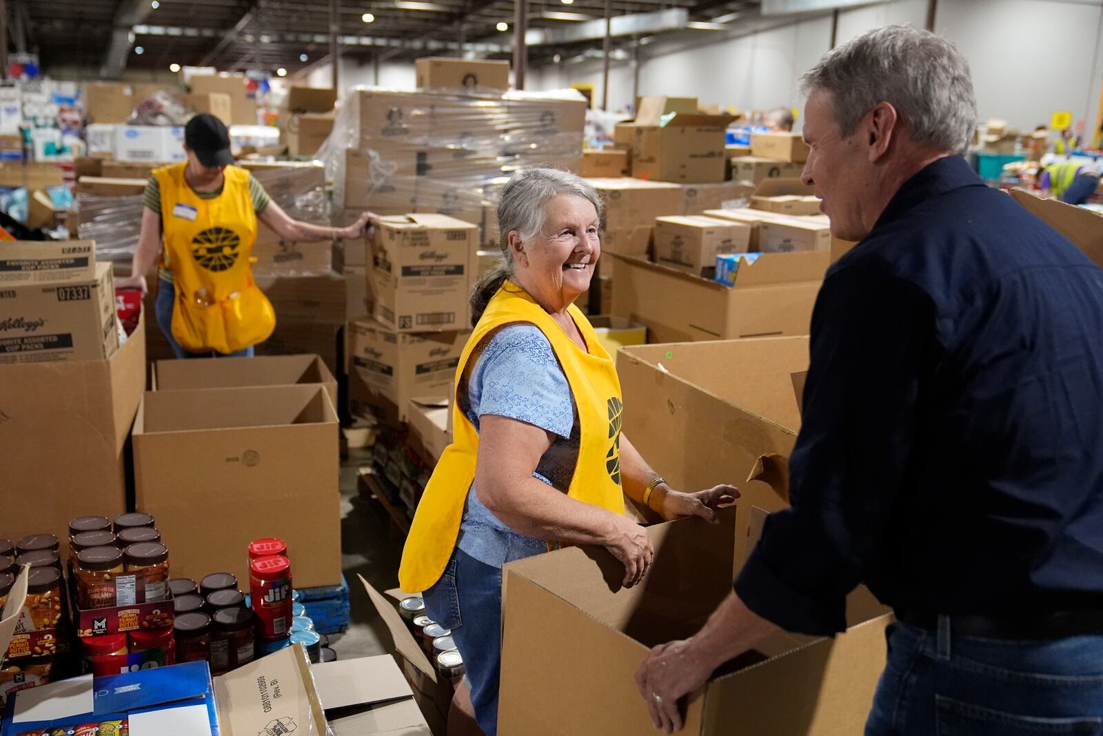 Volunteer Ann Davis speaks with Gov. Bill Lee, right, during his visit to the East Tennessee Disaster Relief Center, for Hurricane Helene disaster response Monday, Oct. 7, 2024, in Bristol, Tenn. (AP Photo/George Walker IV via Pool)