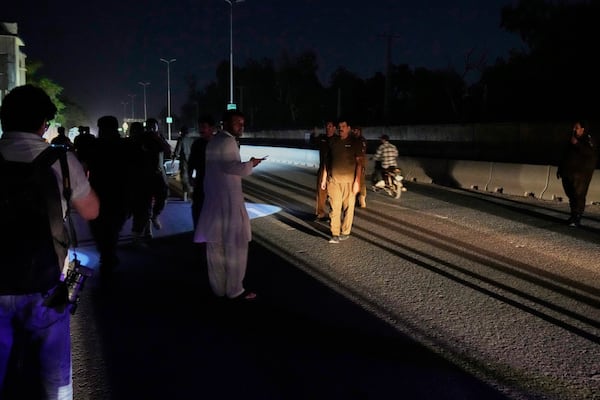 Police officers remove vehicles and people from the main entry of Nur Khan airbase following Indian missile strike on airbase, in Rawalpindi, Pakistan, Saturday, May 10, 2025. (AP Photo/Anjum Naveed)