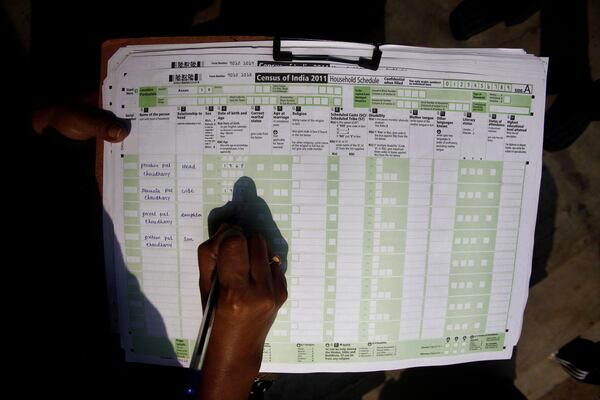 FILE -A census official collects information from a household in Bonda, on the outskirts of Gauhati, India, Feb. 11, 2011. (AP Photo/Anupam Nath, File)