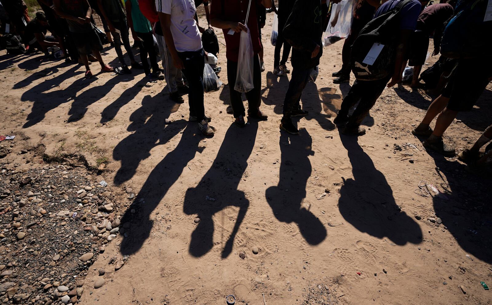 FILE - Migrants wait to be processed by the U.S. Customs and Border Patrol after they crossed the Rio Grande and entered the U.S. from Mexico, on Oct. 19, 2023, in Eagle Pass, Texas. (AP Photo/Eric Gay, File)