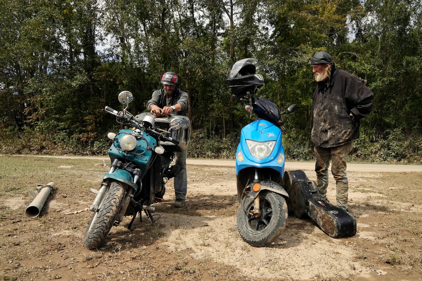 Friends Robert Smith and David Mayben salvage items from the home of a family member who passed away in flooding, Tuesday, Oct. 1, 2024 in Hendersonville, N.C., in the aftermath of Hurricane Helene. (AP Photo/Brittany Peterson)