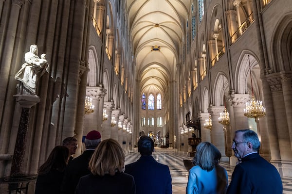 French President Emmanuel Macron, center, and his wife Brigitte Macron, second right, visit the restored interiors of the Notre-Dame de Paris cathedral, Friday, Nov. 29, 2024 in Paris. (Christophe Petit Tesson/Pool via AP)