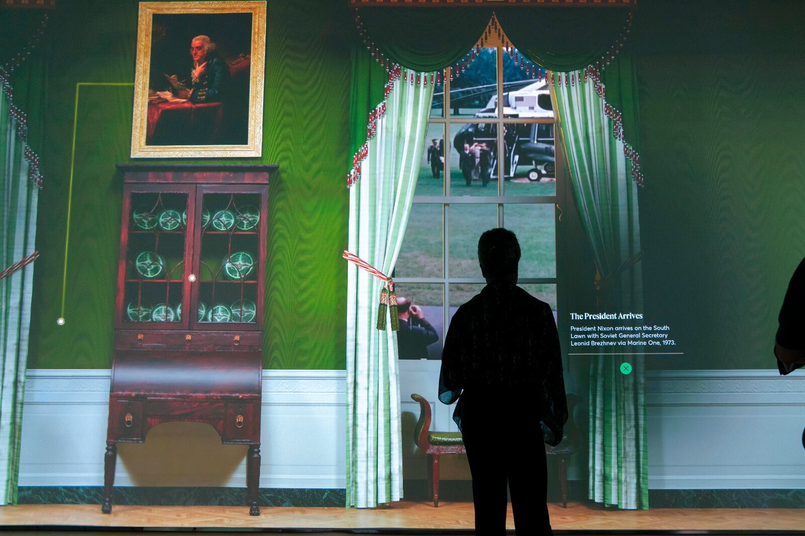 Members of the media tour an interactive 3D room of the White House Green Room as is today, shown at The People's House exhibit, Monday, Sept. 16, 2024 in Washington. (AP Photo/Jose Luis Magana)