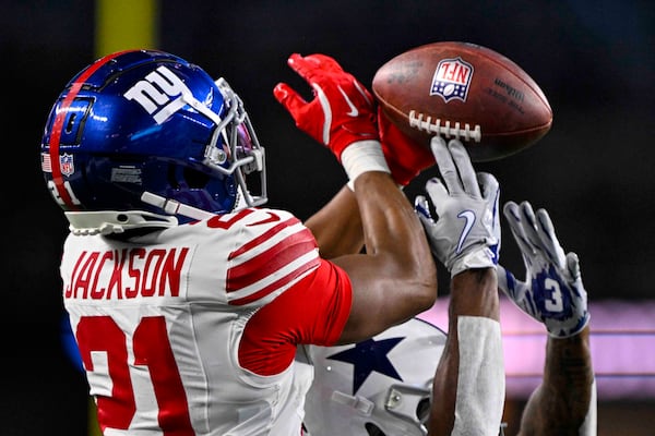 New York Giants cornerback Adoree' Jackson (21) breaks up a pass to Dallas Cowboys wide receiver Jonathan Mingo (81) during the second half of an NFL football game in Arlington, Texas, Thursday, Nov. 28, 2024. (AP Photo/Jerome Miron)