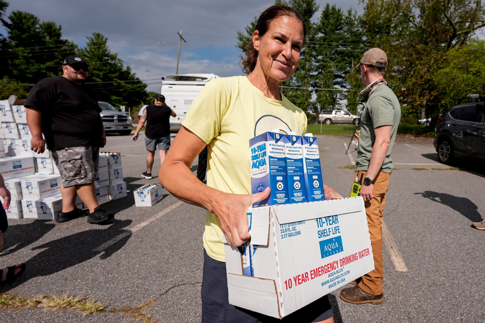 Volunteers stage water for citizens in the aftermath of Hurricane Helene, Monday, Sept. 30, 2024, in Asheville, N.C. (AP Photo/Mike Stewart)