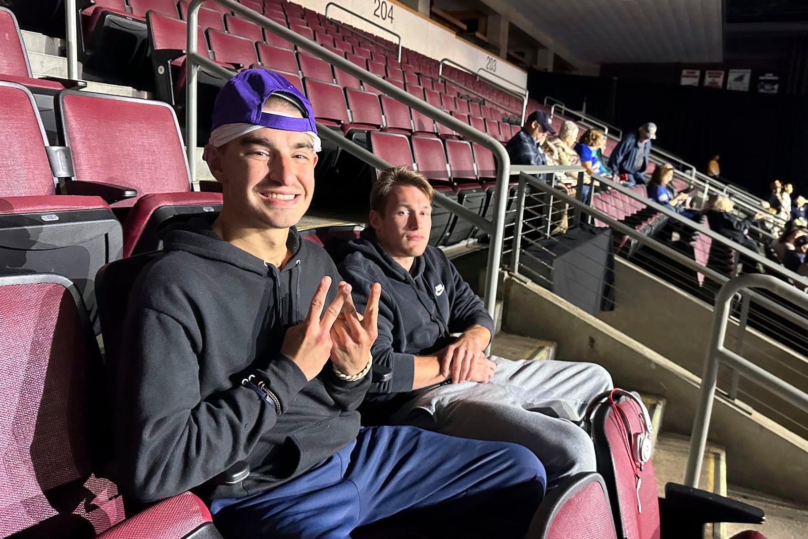 Robert Cabaniss, 28, left, and Taylor Lyze, 25, of Pittsburgh, await the start of a Democratic presidential candidate Vice President Kamala Harris rally at Erie Insurance Arena in Erie, Pa., Monday, Oct. 14, 2024. (AP Photo/Carolyn Thompson)