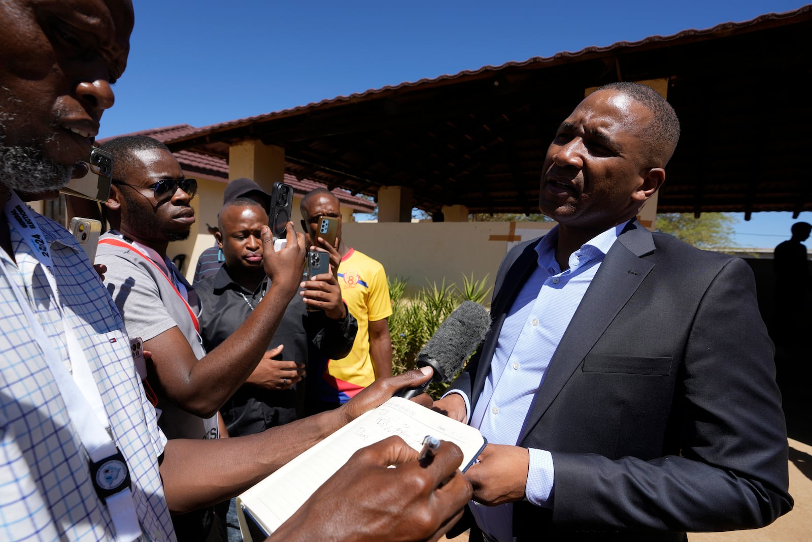 Umbrella for Democratic Change (UDC) presidential candidate Duma Boko speaks to journalist after casting his vote during the elections in Gaborone, Botswana, Wednesday, Oct. 30, 2024. (AP Photo/Themba Hadebe)