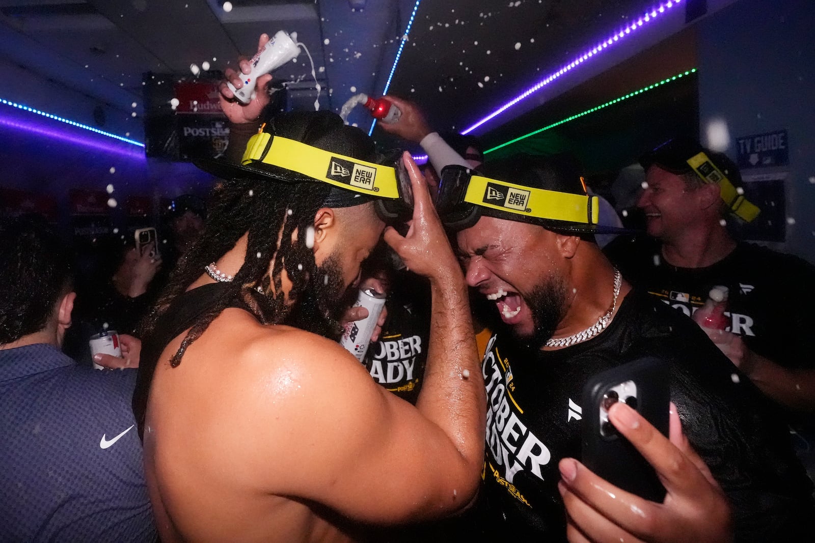 San Diego Padres' Fernando Tatis Jr., left, celebrates with a teammate after the Padres clinched a playoff spot with a triple play to end their baseball game against the Los Angeles Dodgers, Tuesday, Sept. 24, 2024, in Los Angeles. (AP Photo/Mark J. Terrill)