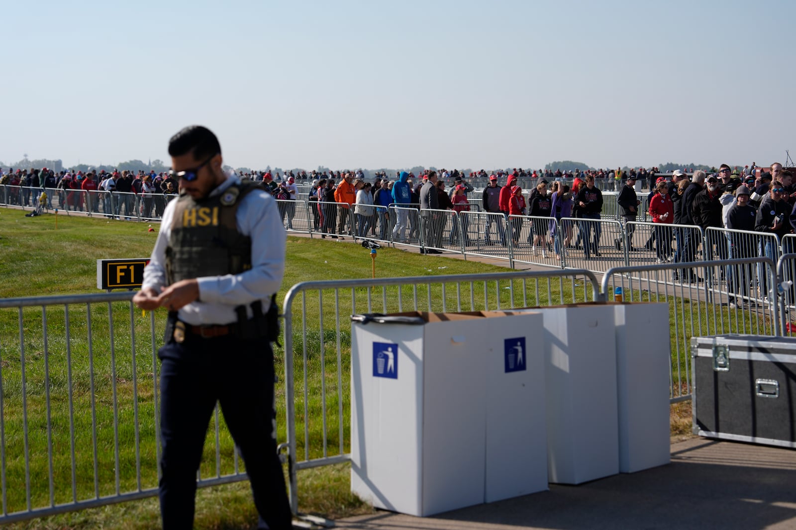 Attendees wait in line before a campaign rally for Republican presidential nominee former President Donald Trump at Dodge County Airport, Sunday, Oct. 6, 2024, in Juneau, Wis. (AP Photo/Julia Demaree Nikhinson)