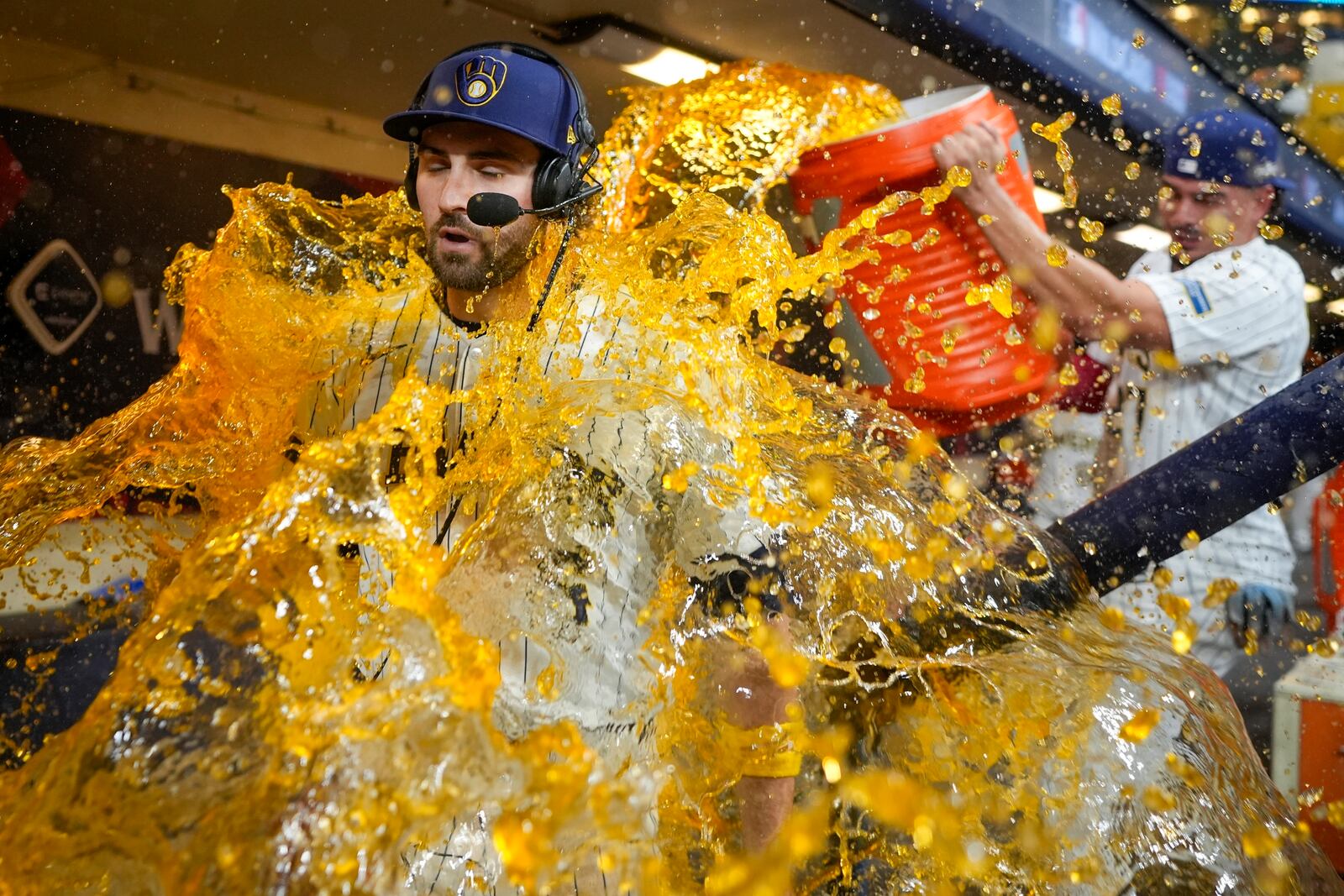 Milwaukee Brewers' Garrett Mitchell is douced by Willy Adames after Game 2 of a National League wild card baseball game against the New York Mets Wednesday, Oct. 2, 2024, in Milwaukee. The Brewers won 5-3 to tie the series 1-1. (AP Photo/Morry Gash)