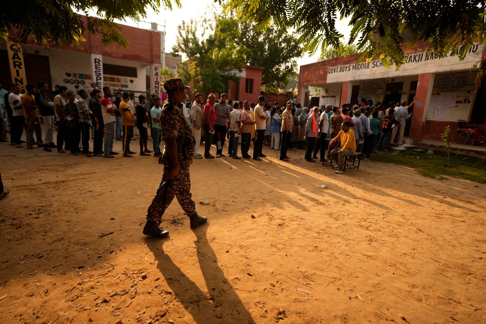 People queue up to cast their vote at a polling booth during the third phase of the Jammu and Kashmir Assembly election in Jammu, India, Tuesday, Oct. 1, 2024. (AP Photos/Channi Anand)