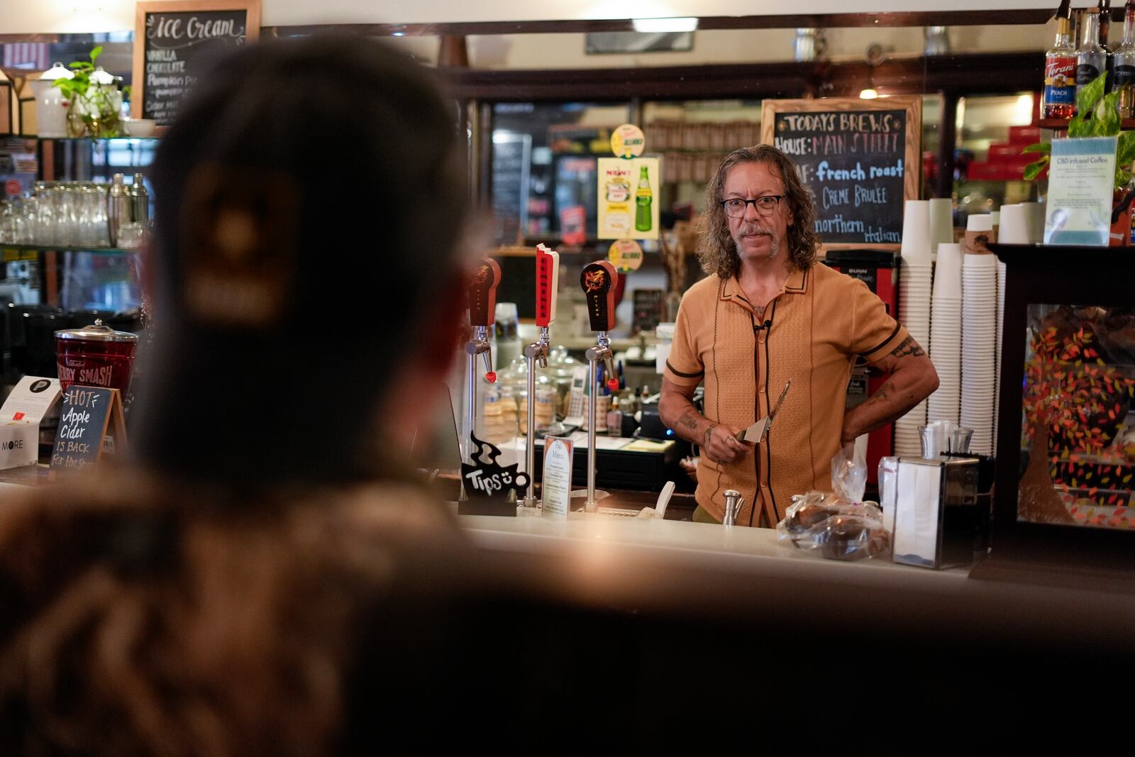 Barry Cummings speaks with Jim Perry who witnessed an assassination attempt against Republican presidential nominee former President Donald Trump, at his shop Cummings Candy & Coffee in Butler, Saturday, Sept. 28, 2024. (AP Photo/Matt Rourke)