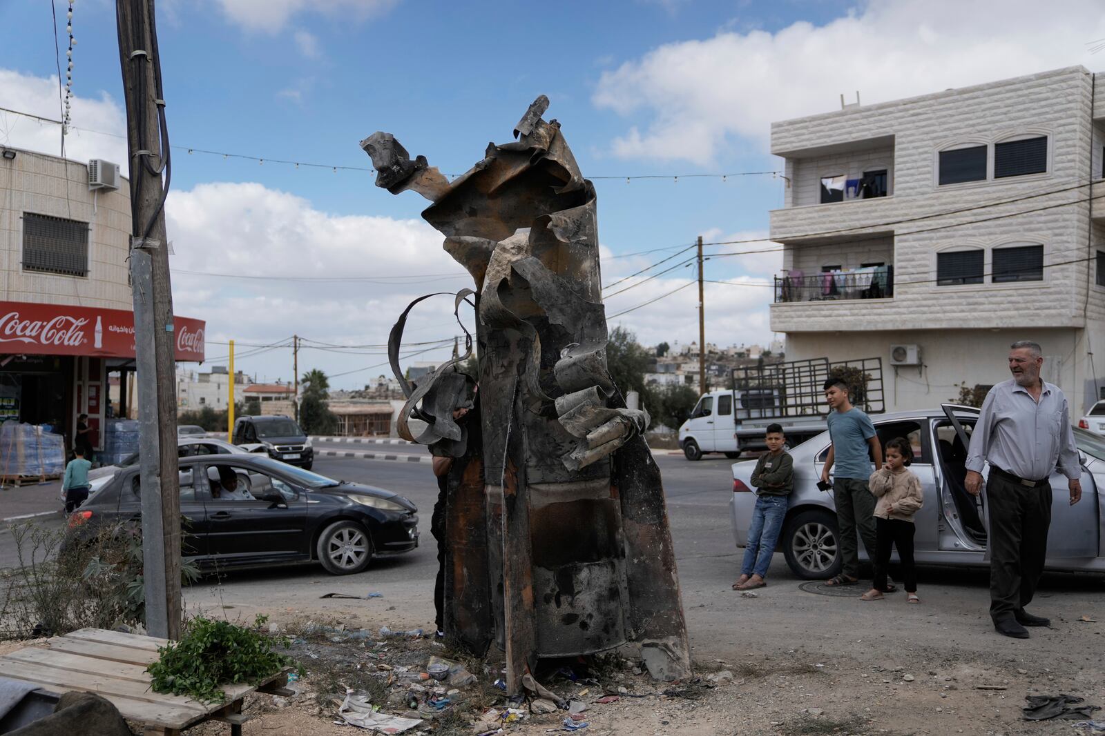 FILE - Palestinians inspect the debris of an Iranian missile intercepted by Israel, in the West Bank city of Hebron, Oct. 2, 2024. (AP Photo/Mahmoud Illean, File)