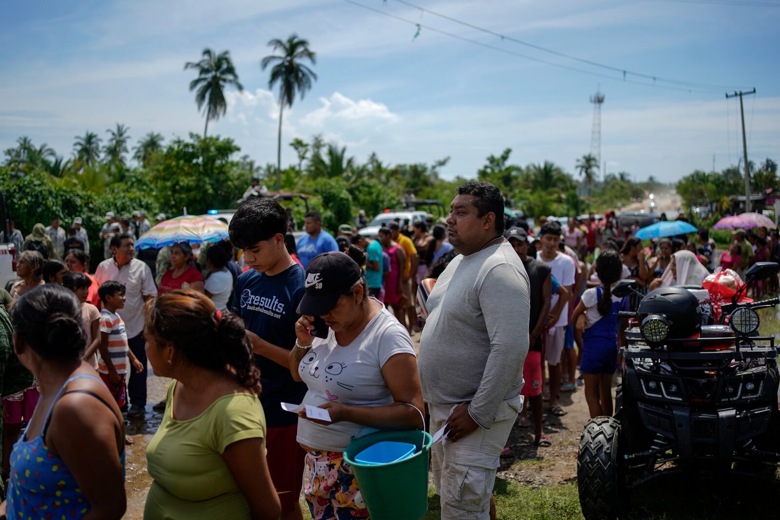 Residents line up to receive food delivered by the Army after Hurricane John passed through Coyuca de Benitez, Guerrero Mexico, Monday, Sept. 30, 2024. (AP Photo/Felix Marquez)